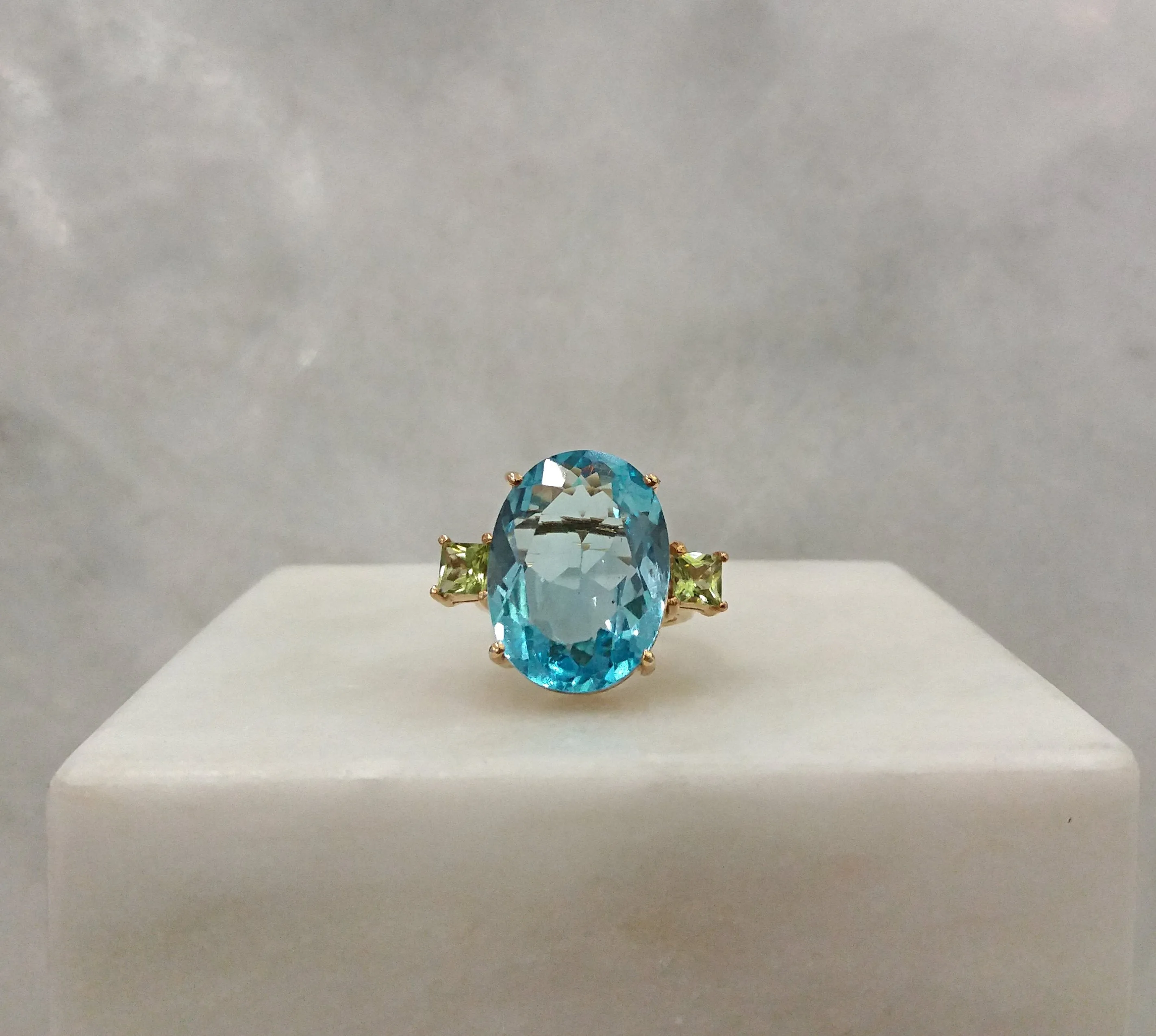 Oval Blue Topaz with princess cut Peridot sidestones Cocktail Ring
